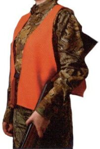 Hunter wearing orange safety vest with rifle