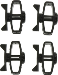 Four black plastic slot car wheels on white background