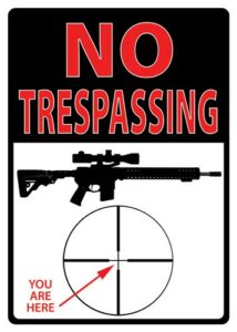 No Trespassing sign with rifle and target.