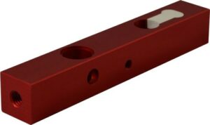 Red metal component with multiple holes and design.