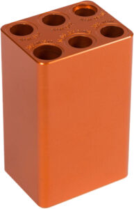 Orange anodized aluminum block with six holes.