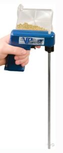 Hands holding a blue bullet reloading tool.