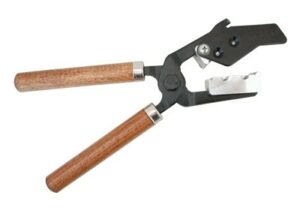 Wood-handled hoof nipper tool for trimming hooves.