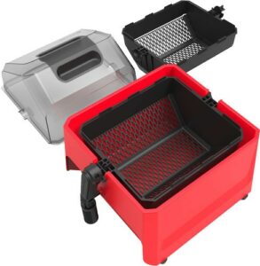 Red air fryer with removable basket and lid.
