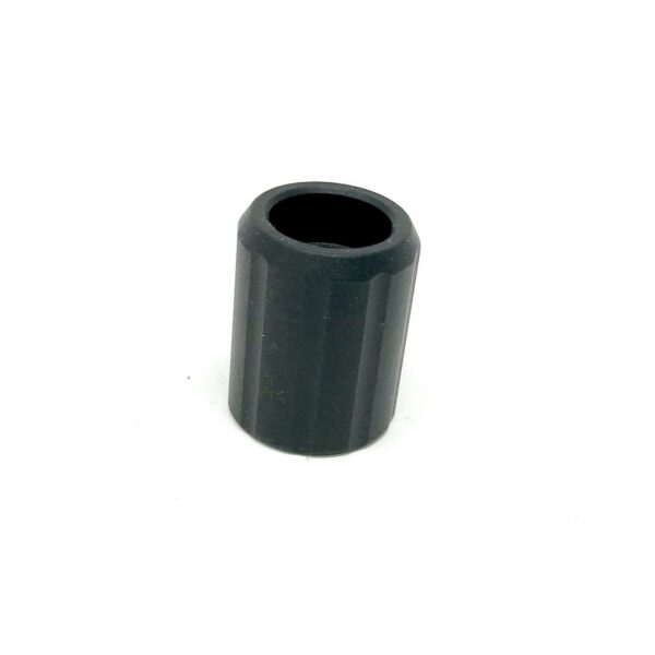 Black cylindrical plastic cap on white background.