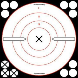 Circular shooting target with scoring rings and stickers.