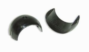 Two black semicircular plastic clips on white background.