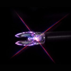 Surgical tool with glowing light and dark background.