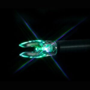 Glowing green surgical laser tip on black background.