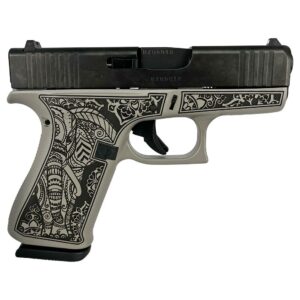 Engraved handgun with detailed black floral design.