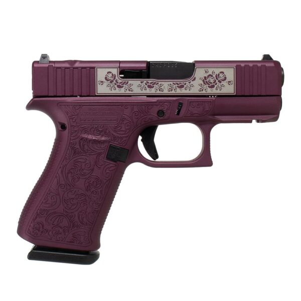 Purple handgun with floral engraving design.