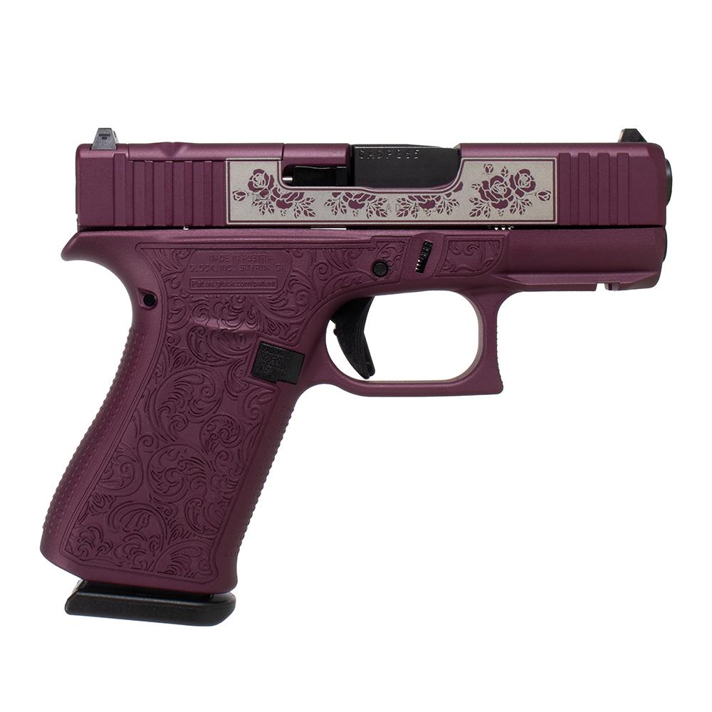 Purple handgun with floral engraving design.