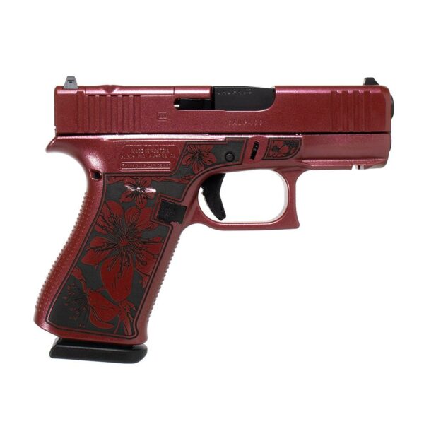 Red floral-designed handgun on white background.