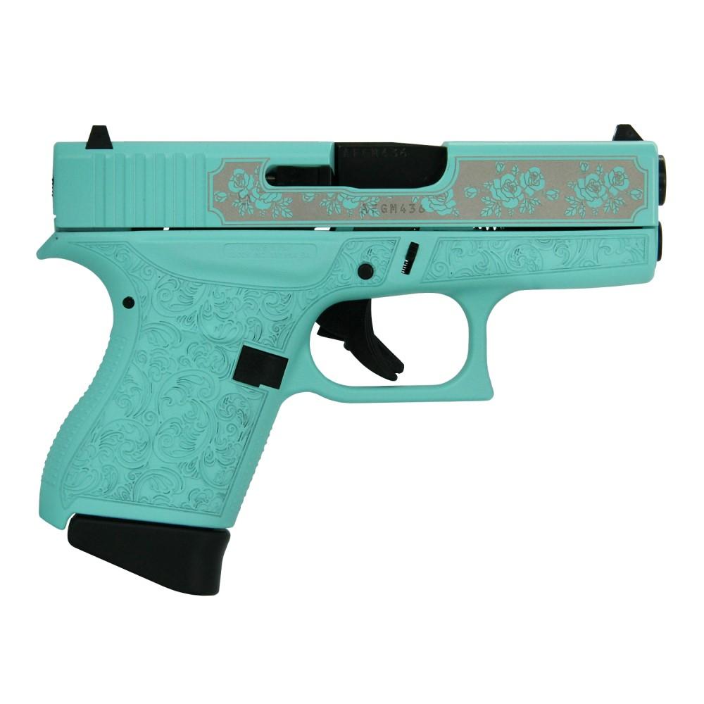 Turquoise handgun with floral engravings