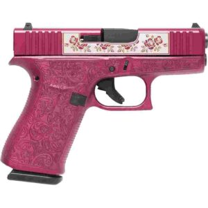 Decorative pink handgun with floral engraving