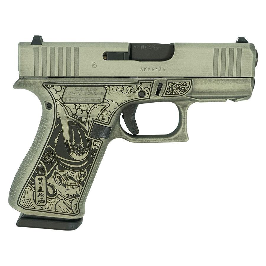 Decorative handgun with engraved samurai design.