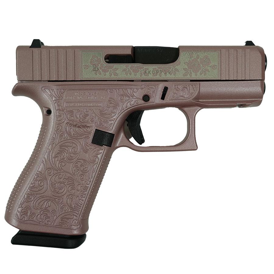 Ornate engraved handgun with floral design