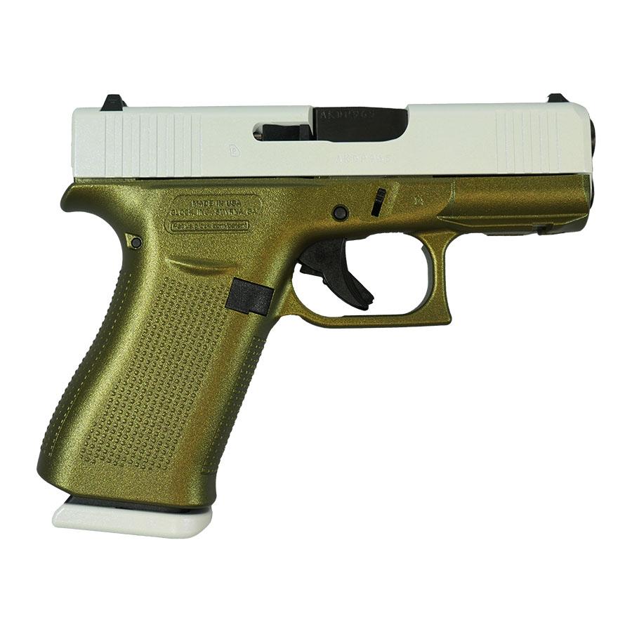 Gold and silver handgun side view