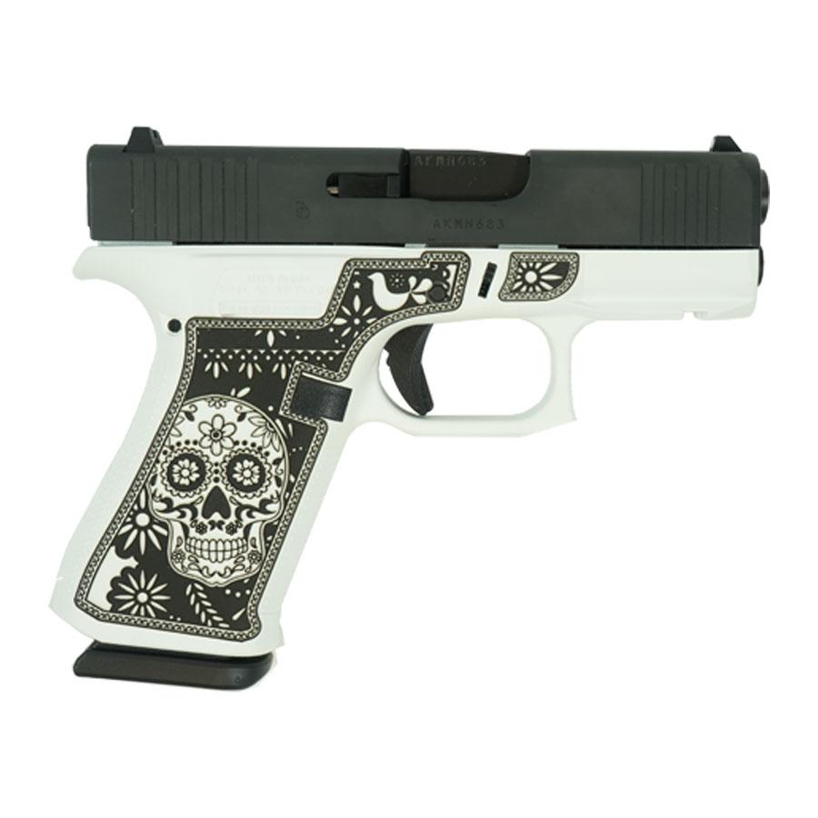 Decorative pistol with skull design on handle.