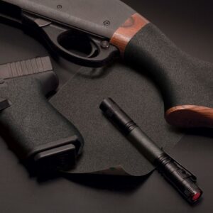 Flashlight and firearms on black surface