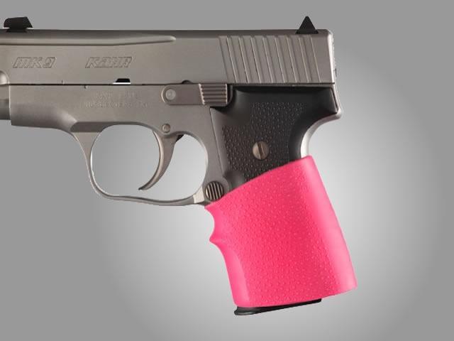 Handgun with pink grip on gray background