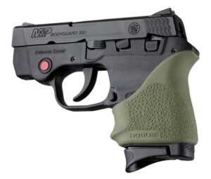 Compact handgun with green grip and laser sight