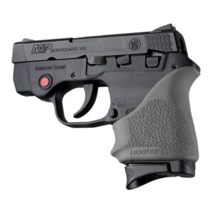 Black handgun with laser sight and textured grip