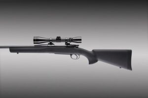 Black hunting rifle with scope on gray background.