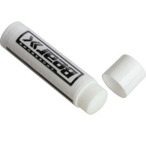 Open lip balm tube on white background.