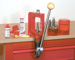 Red reloading press and supplies on workbench