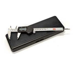 Digital caliper on black case for precision measurement.