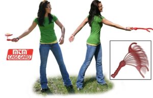 Woman demonstrating clay target thrower outdoors.