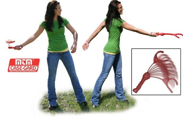Woman demonstrating clay target thrower outdoors.