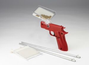 Red seeder tool with accessories on white background.