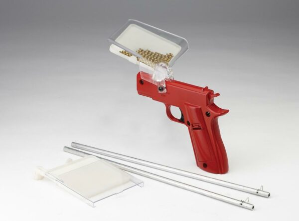 Red seeder tool with accessories on white background.