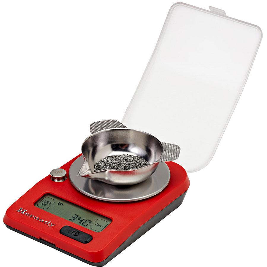 Digital reloading scale with powder on tray.