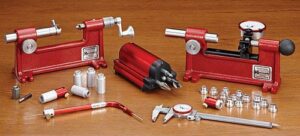 Precision gun reloading tools and accessories displayed.