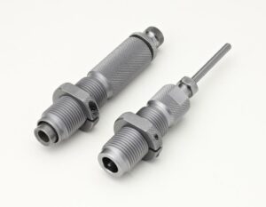 Two metallic threaded mechanical tools on white background.