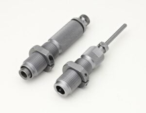 Metallic threading tools on white background.