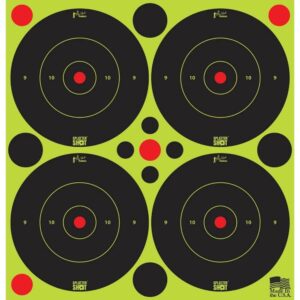 Four black shooting targets on green background.