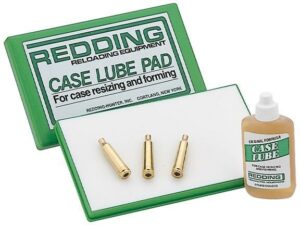Redding case lube pad with three brass cases.
