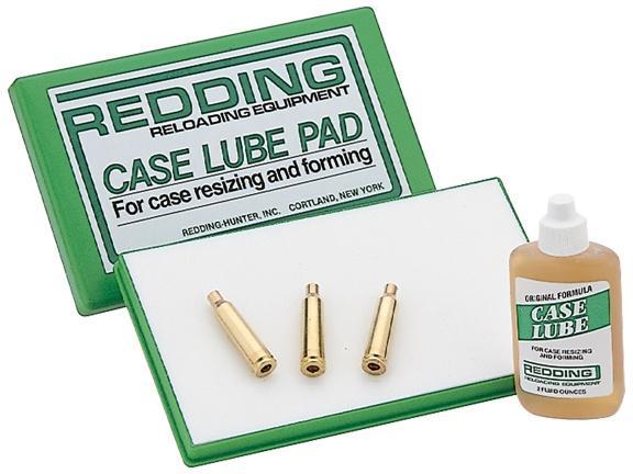 Redding case lube pad with three brass cases.
