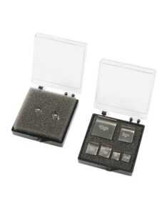 Shotgun pellet and weight scale set in cases.