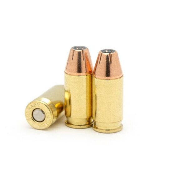 Three copper-tipped pistol bullets on white background.