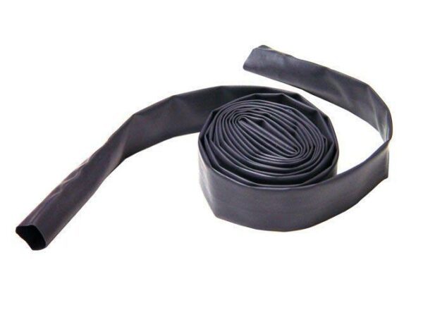 Rolled irrigation drip tape on white background.