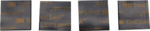 Four 3M Dual Lock fastener squares
