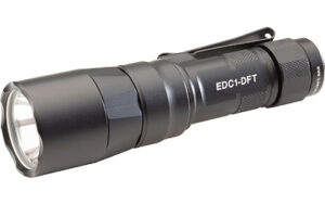 Black tactical flashlight on white background