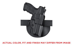 Black pistol in a holster on a belt.