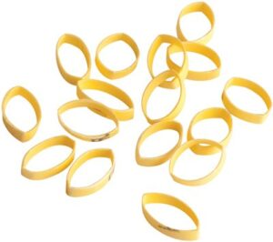 Scattered yellow rubber bands on white background