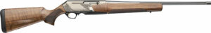 Wood and metal hunting rifle with decorative engravings.